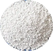 A circular close-up of white granular material, likely salt, sugar, or ice crystals, filling the frame against a white background.